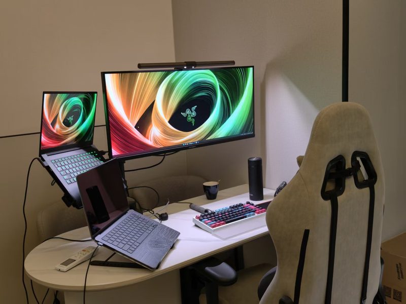 Side view of the desk with a monitor arm and ultrawide screen