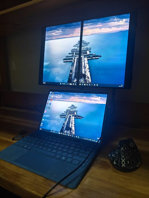 Surface Pro with a stacked dual-screen portable monitor at night