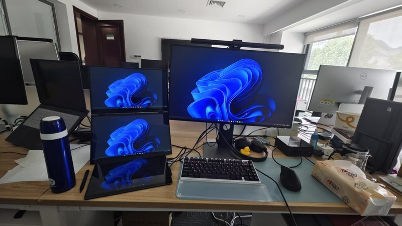 Office desk with four screens