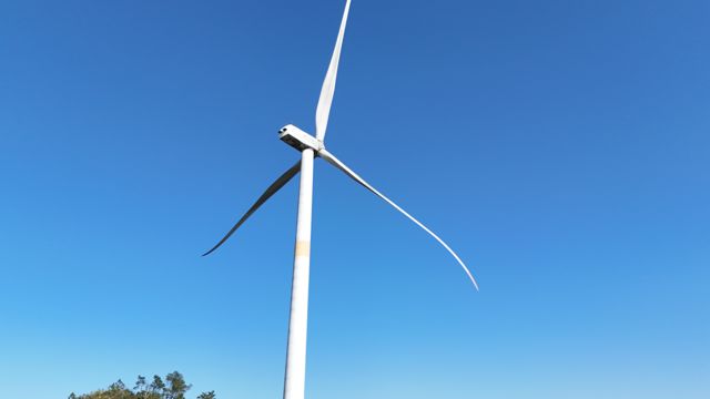 Wind turbine against a blue sky