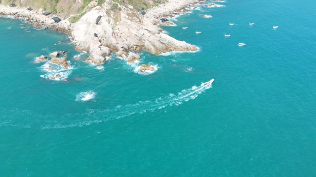 Speedboat leaving a wake along the coast