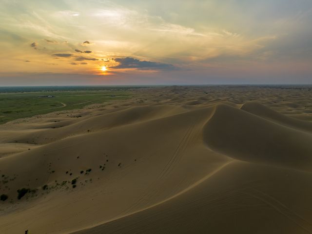 Golden light over rolling sand dunes