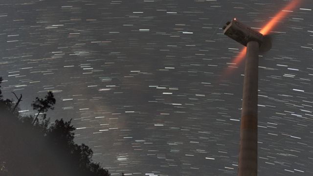 Star trails over a wind turbine